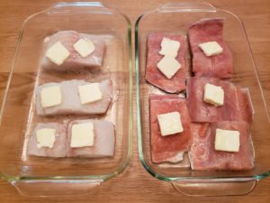 Fish in baking pan with butter on it