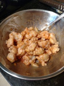 mixing cauliflower in bowl